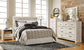 Bellaby Queen Panel Headboard with Mirrored Dresser, Chest and 2 Nightstands